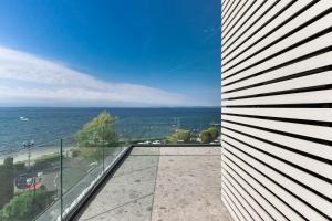 a view of the ocean from the balcony of a house at MaisonMe Boutique Hotel in Bardolino