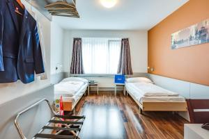 Postel nebo postele na pokoji v ubytování Alexander Guesthouse Zurich Old Town + 31 fotografií
