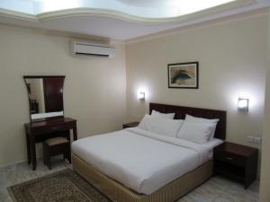 Postel nebo postele na pokoji v ubytování Al Ferdous Hotel Apartments