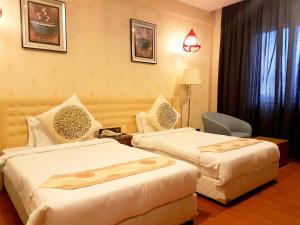 Letto o letti in una camera di Pal Heights Mantra