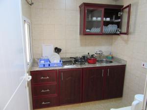 a kitchen with a sink and a counter top at Al Ferdous Hotel Apartments in Muscat