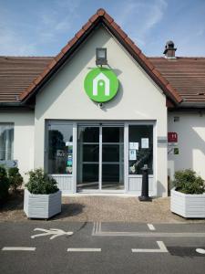 a gas station with a sign on the front of it at Campanile Creil - Villers-Saint-Paul in Villers-Saint-Paul