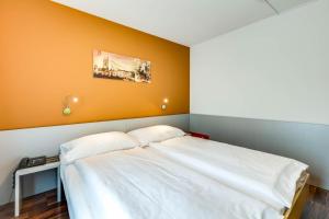 Ein Bett oder Betten in einem Zimmer der Unterkunft Alexander Guesthouse Zurich Old Town