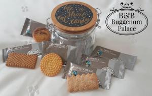 a jar of biscuits and cookies on a table at Gastenverblijf Buggenum Palace in Buggenum