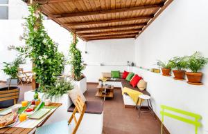 a room with plants on the wall and tables at City Garden Bed and Breakfast in Valencia