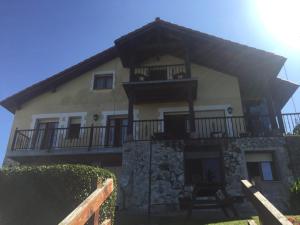 a large house with a balcony on top of it at Apartamentos Carmen de Castro in Comillas