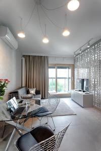 a living room with a couch and a table and chairs at Mennica Residence in Warsaw