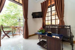 - un salon avec une grande fenêtre et une table dans l'établissement Hoa Thu Homestay, à Hội An