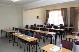 a classroom with tables and chairs in a room at Ikaze Guest House in Boksburg