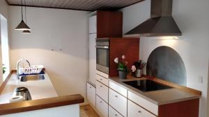 a kitchen with a sink and a stove top oven at Aalborg City Rooms ApS in Aalborg