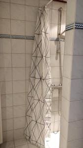 a shower with a shower curtain in a bathroom at Aalborg City Rooms ApS in Aalborg