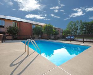 a swimming pool in front of a building at Baymont by Wyndham Rocky Mount in Rocky Mount