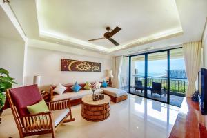 a living room with a couch and a table at Ocean Sonic Resort Sanya in Sanya