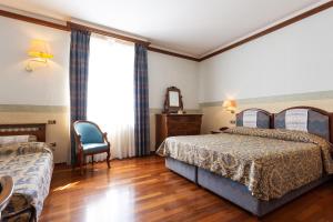 Letto o letti in una camera di Albergo Il Cacciatore