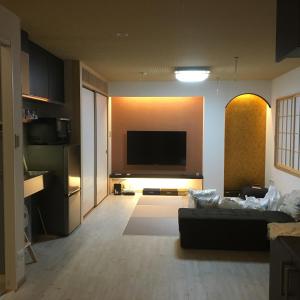 a living room with a couch and a flat screen tv at Tokyo inn Sakura An in Tokyo