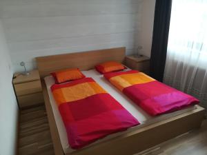 a bedroom with two beds with colorful blankets at Appartement Inge in Kaprun