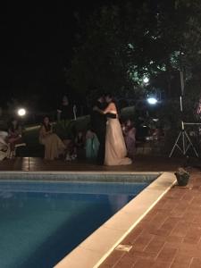 Panna młoda tańcząca w nocy przy basenie w obiekcie Tenuta Due Laghi w mieście Rivodutri