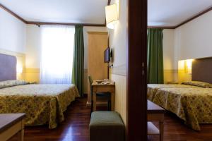 Letto o letti in una camera di Albergo Il Cacciatore