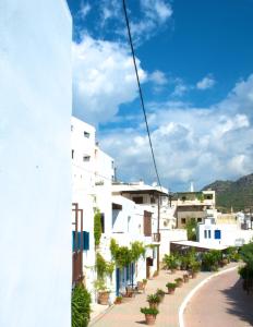 a view from a balcony of a white building at Τhe White Houses in Makry Gialos