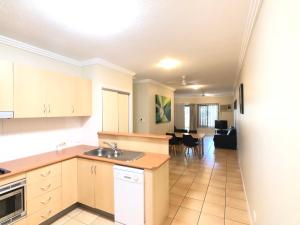 a kitchen with a sink and a counter top at City Plaza Apartments in Cairns