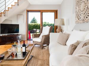 a living room with a white couch and a table with wine bottles at Belvilla by OYO Viagrande in Trecastagni