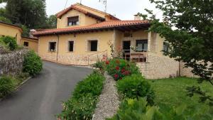 a house with a road in front of it at La Casina in Celorio +7 photos