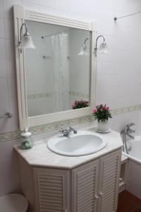 a bathroom with a sink and a mirror and a tub at Quinta do Sardão in Boticas