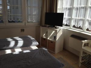 a room with two beds and a flat screen tv at Bungalow Beachhouse in Boltenhagen