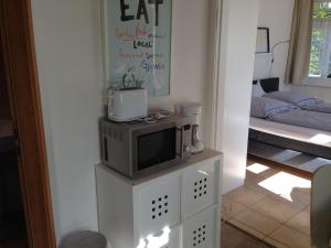 a living room with a tv on a white cabinet at Bungalow Beachhouse in Boltenhagen