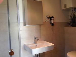 a bathroom with a sink and a shower at Bungalow Beachhouse in Boltenhagen
