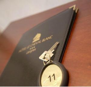 a small clock sitting on top of a book at Logis Hôtel Le Cheval Blanc in Langres