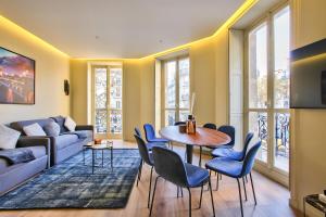 uma sala de estar com um sofá, uma mesa e cadeiras em 60-LUXURY PARISIAN HOME SEBASTOPOL (2DG) em Paris