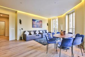 a living room with a couch and a table and chairs at 60-LUXURY PARISIAN HOME SEBASTOPOL (2DG) in Paris