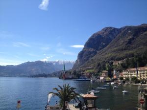 a view of a body of water with boats in it at Hotel Du Lac Menaggio in Menaggio