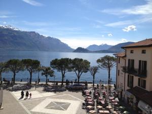a view of a body of water with a group of people at Hotel Du Lac Menaggio in Menaggio