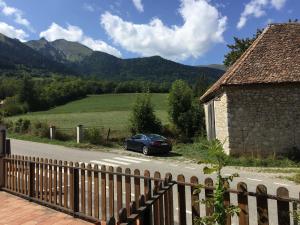 a car parked on a road next to a house at Auberge du Grand Champ in Lalley