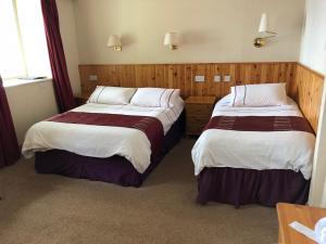 Voodi või voodid majutusasutuse Port Askaig Hotel toas