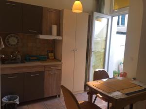a kitchen with a table and a dining room at Crown Street Garden Studio in Belgrade