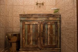 a wooden cabinet in a bathroom with a sink at Limeni Inn Boutique Hotel Adults only 12plus in Limeni +77 photos