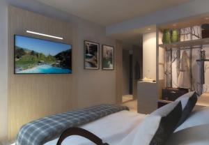 a hotel room with a bed and a television at Ròseo Euroterme Wellness Resort in Bagno di Romagna