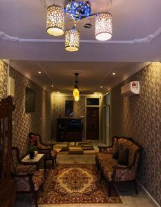 a living room with two chairs and a couch at Bayan Baru Homestay @ Taman Sri Nibong in George Town