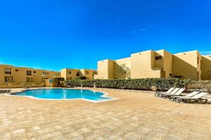 a courtyard with a swimming pool in front of a building at Townhouse La Tejita in La Tejita