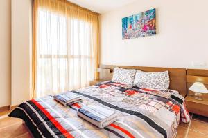 a bedroom with a bed with a quilt on it at Townhouse La Tejita in La Tejita +18 photos