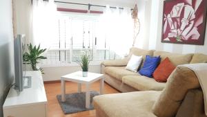 a living room with a couch and a table at Arinaga Luxury House Beach in Arinaga