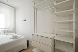 A bed or beds in a room at Pratello Suite Apartment