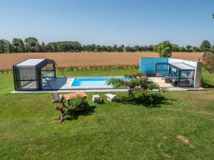 a house with a swimming pool in a field at La Maynadie in Andouque