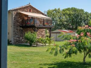 a house with a deck on the side of it at La Maynadie in Andouque