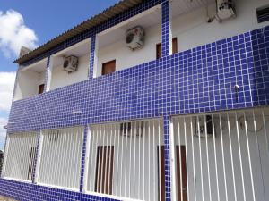 馬塞約的住宿－POUSADA OLÍMPIA，一边是蓝色瓷砖的建筑