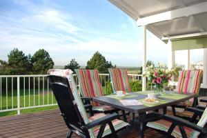 a table and chairs on a deck with a view at Ostrea 16 in Kamperland