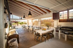 a dining room with tables and chairs and windows at Aparthotel Camp El Planet in L’Alfàs del Pi